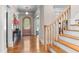Welcoming foyer with wood floors, staircase, and arched doorway at 116 Hibiscus Dr, Clayton, NC 27527