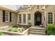 Elegant front entrance with brick facade, fountain and well-manicured landscaping at 116 Hibiscus Dr, Clayton, NC 27527