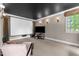 Home theater featuring projector screen, black ceiling and neutral carpeting at 116 Hibiscus Dr, Clayton, NC 27527