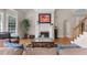 Cozy living room with fireplace, hardwood floors, and large windows at 116 Hibiscus Dr, Clayton, NC 27527