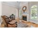 Cozy living room featuring a fireplace, hardwood floors, and large windows at 116 Hibiscus Dr, Clayton, NC 27527