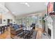 Spacious living room with vaulted ceiling, fireplace, large windows and hardwood floors at 116 Hibiscus Dr, Clayton, NC 27527