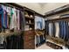 Large walk-in closet with wooden organizers for folded and hanging clothes and shoes at 116 Hibiscus Dr, Clayton, NC 27527