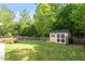 Expansive backyard featuring a storage shed and a well-maintained lawn enclosed by a fence at 1230 Sunday Silence Dr, Knightdale, NC 27545