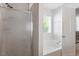 Bright bathroom features a tiled shower, soaking tub, and window at 1230 Sunday Silence Dr, Knightdale, NC 27545