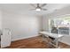 Bright bedroom with a ceiling fan, hardwood floors, a large window, and a work space at 1230 Sunday Silence Dr, Knightdale, NC 27545