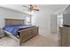Spacious bedroom features neutral carpet, large window, ceiling fan and furniture at 1230 Sunday Silence Dr, Knightdale, NC 27545