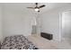 Bright bedroom with carpet flooring, ceiling fan, and walk-in closet at 1230 Sunday Silence Dr, Knightdale, NC 27545
