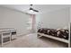 Cozy bedroom featuring a ceiling fan, a window with natural light, and a stylish desk area at 1230 Sunday Silence Dr, Knightdale, NC 27545