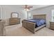 Spacious bedroom features neutral carpet, large window, ceiling fan and furniture at 1230 Sunday Silence Dr, Knightdale, NC 27545