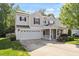 Traditional two-story home with a two-car garage, charming porch, and well-maintained landscaping at 1230 Sunday Silence Dr, Knightdale, NC 27545