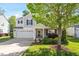 Charming two-story home featuring a well-manicured lawn, brick accents, and an attached two-car garage at 1230 Sunday Silence Dr, Knightdale, NC 27545
