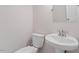 Neat half-bathroom featuring a pedestal sink and toilet at 1230 Sunday Silence Dr, Knightdale, NC 27545