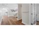 Bright hallway featuring hardwood floors, white walls, and an open view to the dining area at 1230 Sunday Silence Dr, Knightdale, NC 27545