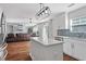 Bright kitchen features white cabinets, stainless steel appliances, and center island, open to the living area at 1230 Sunday Silence Dr, Knightdale, NC 27545
