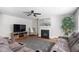 Cozy living room features a fireplace, mounted TV, comfortable seating and view of the kitchen at 1230 Sunday Silence Dr, Knightdale, NC 27545