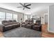 Comfortable living room features plush reclining sofas, a ceiling fan, and connects to the kitchen at 1230 Sunday Silence Dr, Knightdale, NC 27545