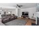 Living room features a fireplace, TV, comfortable seating and view of the kitchen and dining area at 1230 Sunday Silence Dr, Knightdale, NC 27545