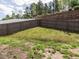 Fenced-in backyard with a small concrete area, offering a private outdoor space at 1242 Underbrush Dr, Durham, NC 27703