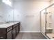Bright bathroom with granite vanity, undermount sink, and shower with glass door at 1242 Underbrush Dr, Durham, NC 27703