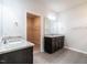 Bathroom showcasing dual vanity sinks, tile floors and a walk-in closet at 1242 Underbrush Dr, Durham, NC 27703