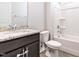 Bathroom with granite vanity, toilet, and shower/tub combination with white tile at 1242 Underbrush Dr, Durham, NC 27703