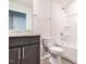 Well-lit bathroom showcasing a granite countertop vanity, toilet, and shower-tub combo at 1242 Underbrush Dr, Durham, NC 27703