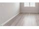 Neutral bedroom with grey walls, white trim and light-colored hardwood flooring at 1242 Underbrush Dr, Durham, NC 27703