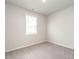 Bedroom with neutral carpet, light walls, and a window with white blinds at 1242 Underbrush Dr, Durham, NC 27703