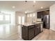 Open kitchen featuring a center island with granite countertops and stainless steel appliances at 1242 Underbrush Dr, Durham, NC 27703