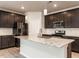 Modern kitchen with granite counters, stainless steel appliances, and pendant lighting at 1242 Underbrush Dr, Durham, NC 27703