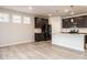 Open floor plan with modern kitchen and island featuring white cabinets, stainless appliances, and granite countertops at 1242 Underbrush Dr, Durham, NC 27703