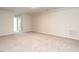 Spacious carpeted living room with access to other rooms at 1242 Underbrush Dr, Durham, NC 27703