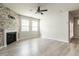Inviting living room with decorative fireplace, ceiling fan and access to outdoor area at 1242 Underbrush Dr, Durham, NC 27703
