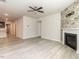 Spacious living room featuring a fireplace, ceiling fan, and open access to the kitchen at 1242 Underbrush Dr, Durham, NC 27703