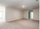 Open concept living room features neutral carpet, light walls, and recessed lighting at 1242 Underbrush Dr, Durham, NC 27703