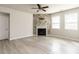 Open living area featuring a decorative stone fireplace and modern ceiling fan at 1242 Underbrush Dr, Durham, NC 27703