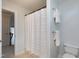 Functional bathroom with tile flooring and a shower, and two hanging towels at 1276 Dalgarven Dr, Apex, NC 27502