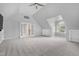 Expansive bedroom with vaulted ceiling, neutral carpet, and an open french door entry to another room at 1276 Dalgarven Dr, Apex, NC 27502