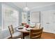 Bright breakfast nook featuring a round table with four chairs and natural light from a bay window at 1276 Dalgarven Dr, Apex, NC 27502