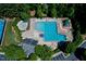 Aerial view of a community pool with lounge chairs, umbrellas, and surrounding trees at 1276 Dalgarven Dr, Apex, NC 27502