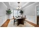 Elegant dining room with hardwood floors, decorative molding, and a chandelier above the table at 1276 Dalgarven Dr, Apex, NC 27502