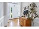 Bright foyer with hardwood floors, a decorative console table, and a view of the front door at 1276 Dalgarven Dr, Apex, NC 27502