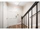 Bright entryway featuring wood floors, staircase with black railing, and a white front door at 13 Patriot Cir, Durham, NC 27704
