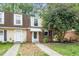 Attractive townhouse with a combination of siding and brick facade and a well-maintained lawn at 13 Patriot Cir, Durham, NC 27704