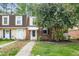 Charming townhouse featuring brick accents, dormer windows and a well maintained front yard and walkway at 13 Patriot Cir, Durham, NC 27704