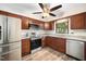 Kitchen with stainless steel appliances, wood cabinets, granite countertops, and modern fixtures at 13 Patriot Cir, Durham, NC 27704