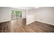 Open room featuring luxury vinyl plank flooring and a sliding glass door to the exterior at 13 Patriot Cir, Durham, NC 27704