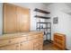 This area features wooden storage cabinets, shelving, and a shelving unit for optimal organization and accessibility at 13 Patriot Cir, Durham, NC 27704