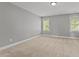 Spacious bedroom featuring neutral walls, carpet, and natural light from two windows at 130 Hilldebrant Dr, Franklinton, NC 27525